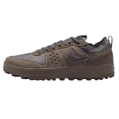 A brown and gray sneaker with a rugged sole and mesh upper, featuring a prominent Nike swoosh logo, along with suede accents and perforated details.
