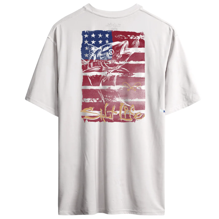 A white T-shirt featuring a graphic of a fish superimposed on an American flag in red, white, and blue, with graffiti-style text at the bottom.