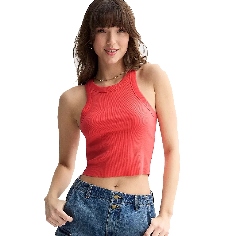 A person is wearing a sleeveless red crop top paired with high-waisted blue jeans.