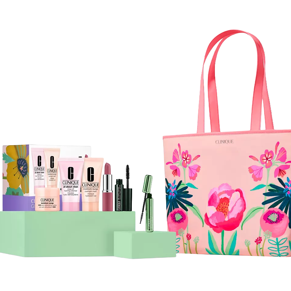 Clinique gift set with skincare and makeup products, including cleansers, moisturizer, lipstick, and mascara, displayed alongside a pink floral tote bag.
