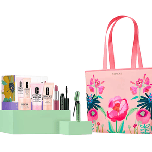 Clinique gift set with skincare and makeup products, including cleansers, moisturizer, lipstick, and mascara, displayed alongside a pink floral tote bag.