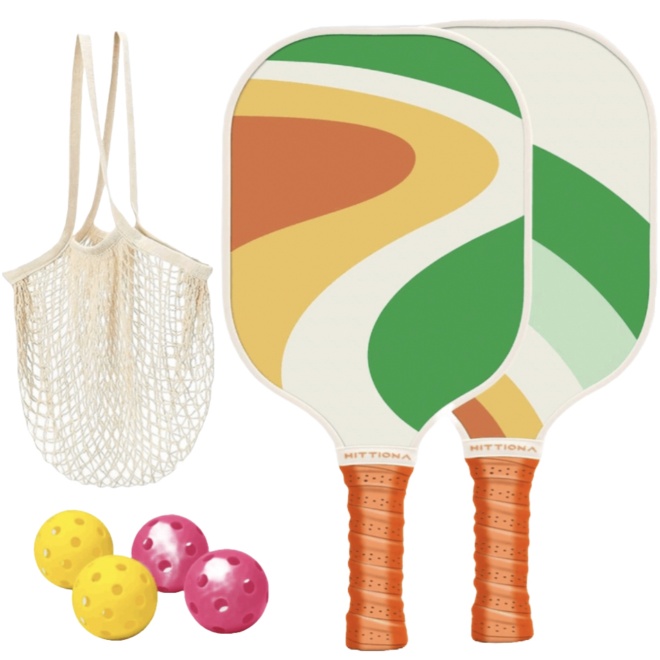 Two pickleball paddles with colorful designs and orange grips, accompanied by a mesh bag and four pickleballs—two yellow and two pink.
