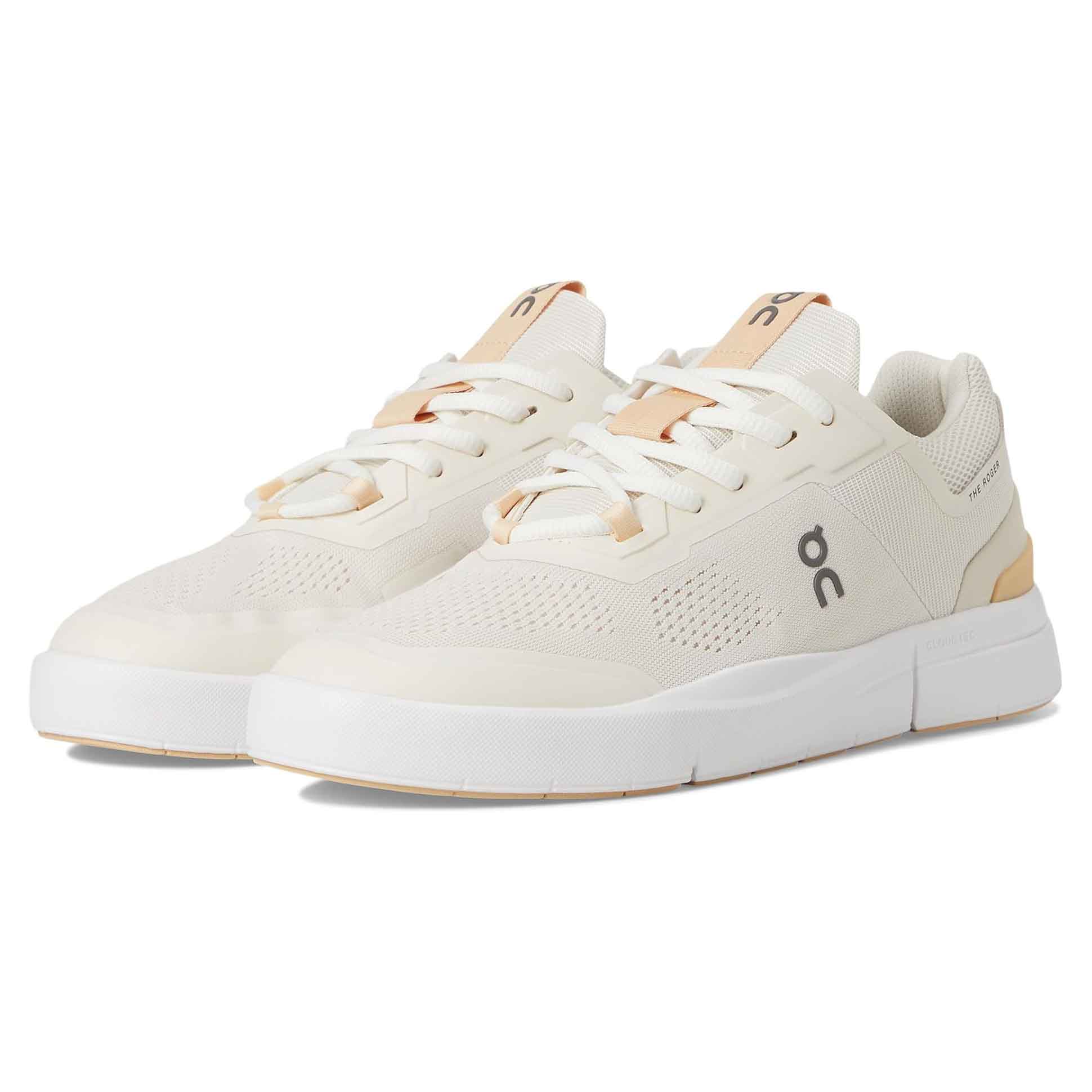 On Women's Roger Spin 2 Sneakers feature a sleek, low-profile design in white with beige accents, a breathable mesh upper, and cushioned sole for comfort.