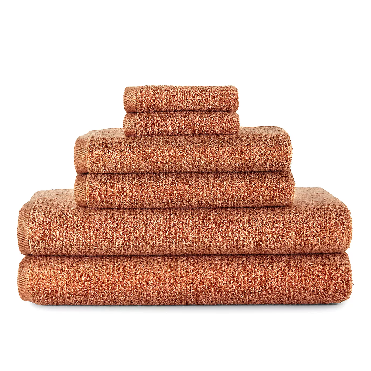 Stack of terracotta-colored towels, including bath towels, hand towels, and washcloths, neatly arranged by size.
