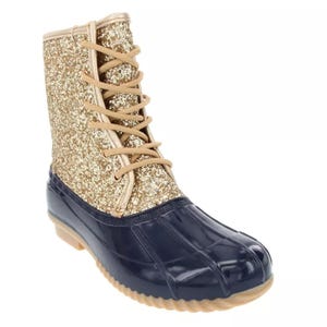 A lace-up boot with a glittery gold upper and a navy blue rubber lower section, designed for wet weather.