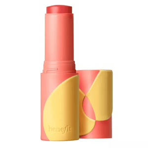 A coral and yellow stick of a tinted lip and cheek balm from Benefit, designed for dual use as a portable, multitasking cosmetic item.