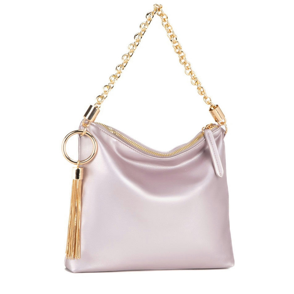 A lavender shoulder bag with a sleek, satin-like finish features a gold chain strap and a decorative gold ring with a tassel. It has a zippered opening for secure storage.
