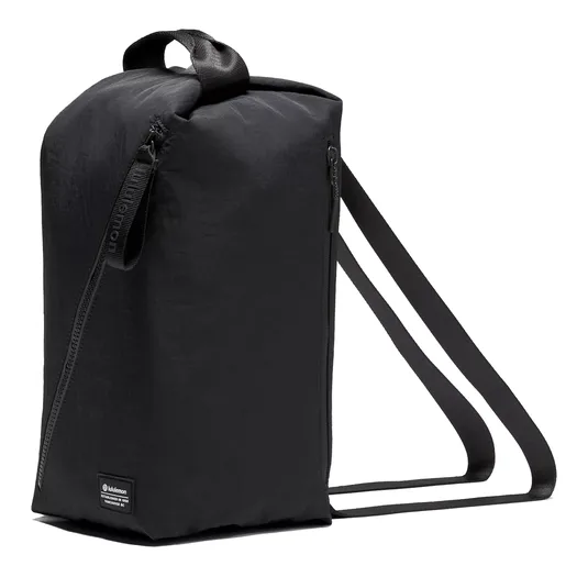 A black rectangular backpack with side zippers and dual shoulder straps, featuring a top handle. Brand label visible at the bottom corner.