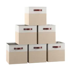 Set of six beige and white fabric storage bins with brown handles, stacked in a pyramid formation.