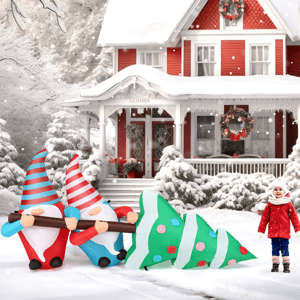 A 7-foot inflatable holiday decoration featuring two gnomes in red and blue outfits carrying a large, stylized Christmas tree with colorful polka dots, set in a snowy winter scene in front of a festive red house.