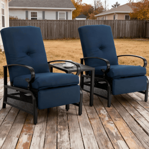 Two blue cushioned recliner chairs with black metal frames are positioned on a wooden deck, separated by a small table holding a white cup and saucer.