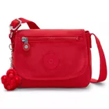 A red Kipling crossbody bag with a zippered front pocket, adjustable strap, and attached fuzzy keychain charm.