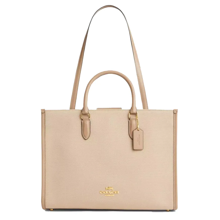 A beige Coach bag with dual handles, a long shoulder strap, gold hardware, and a Coach tag.