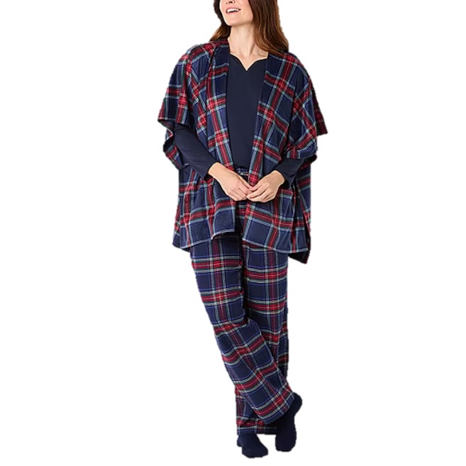 A woman is wearing a plaid loungewear set, including a poncho-style top and matching pants, over a navy long-sleeve shirt.