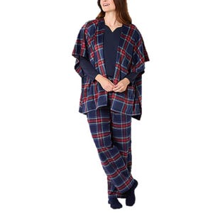 A woman is wearing a plaid loungewear set, including a poncho-style top and matching pants, over a navy long-sleeve shirt.