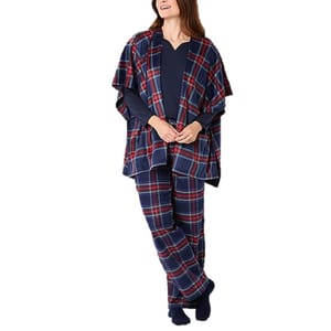 A woman is wearing a plaid loungewear set, including a poncho-style top and matching pants, over a navy long-sleeve shirt.