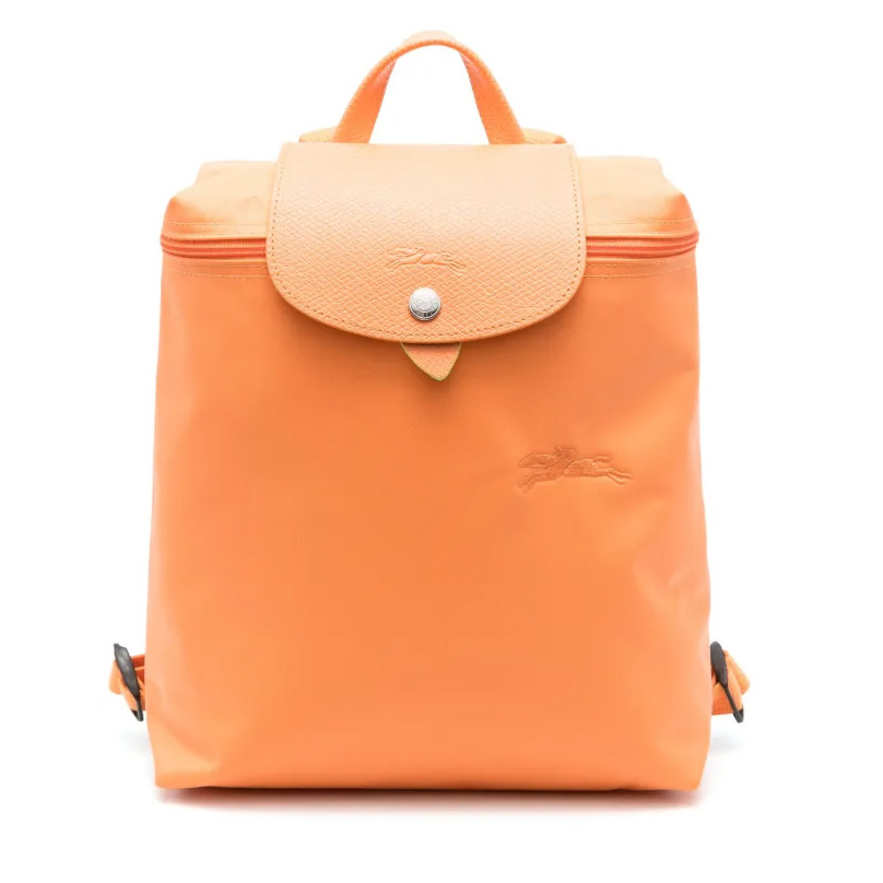 Orange Longchamp Le Pliage Xtra Backpack featuring a flap closure with button snap, top handle, embossed logo, and adjustable straps.