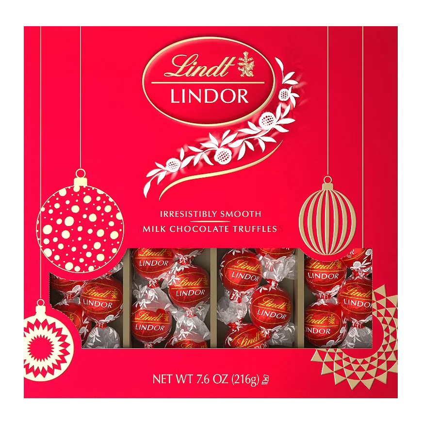 Lindt LINDOR Milk Chocolate Truffles, irresistibly smooth, packaged in a festive red box, net weight 7.6 oz (216g).