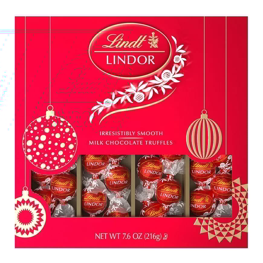 Lindt LINDOR Milk Chocolate Truffles, irresistibly smooth, packaged in a festive red box, net weight 7.6 oz (216g).