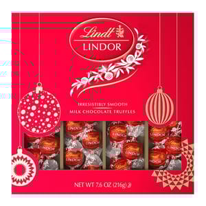 Lindt LINDOR Milk Chocolate Truffles, irresistibly smooth, packaged in a festive red box, net weight 7.6 oz (216g).