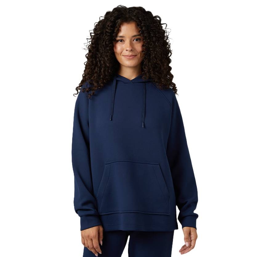 A person is wearing a navy blue hoodie with a front pocket and drawstring hood, along with matching navy blue pants.