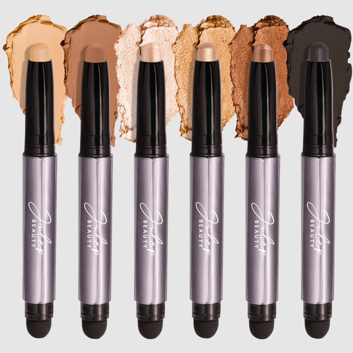 Six shades of concealer sticks with smudged samples demonstrating their respective colors.