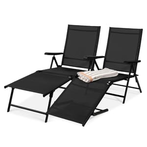 Two black reclining outdoor lounge chairs with adjustable footrests are shown, along with a folded striped towel placed on one of the chairs.