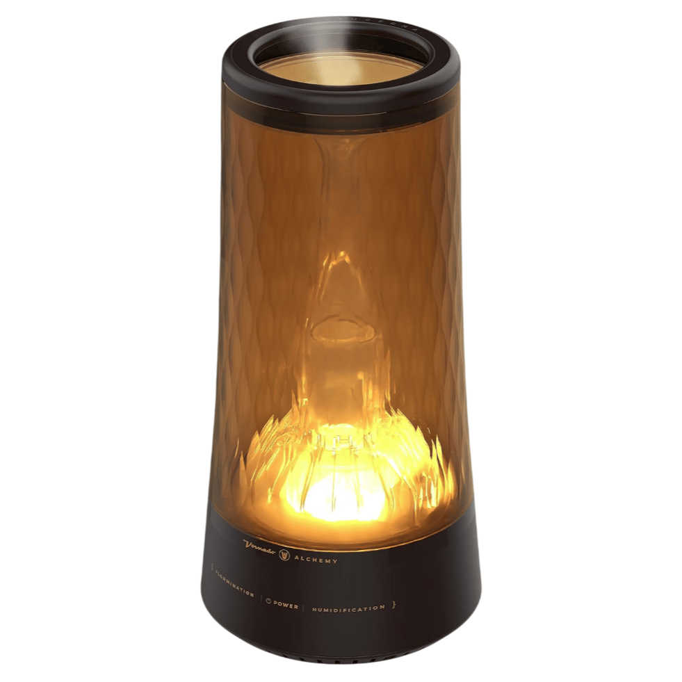 A sleek, amber-colored humidifier with integrated illumination and power controls, labeled \“Vornado Alchemy.\“