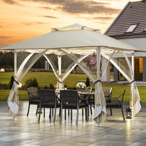 A stylish outdoor canopy with a table and chairs set, featuring a metal frame and fabric roof, surrounded by a landscaped patio and garden at sunset.