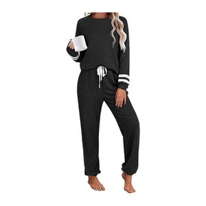 A black loungewear set with white stripes on the sleeves and a drawstring waist.