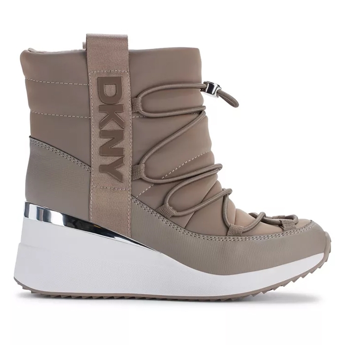 A taupe DKNY women's wedge boot features a padded design with crisscross laces, a metallic accent, and a thick white sole for a stylish, modern look.
