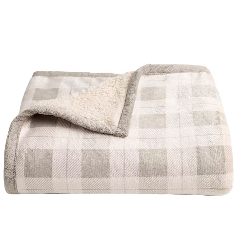 A folded, plaid-patterned blanket with a soft, fluffy lining and neutral tones.