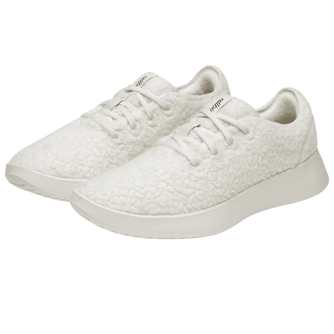 White lace-up sneakers with a textured, fluffy exterior and a streamlined, white sole.