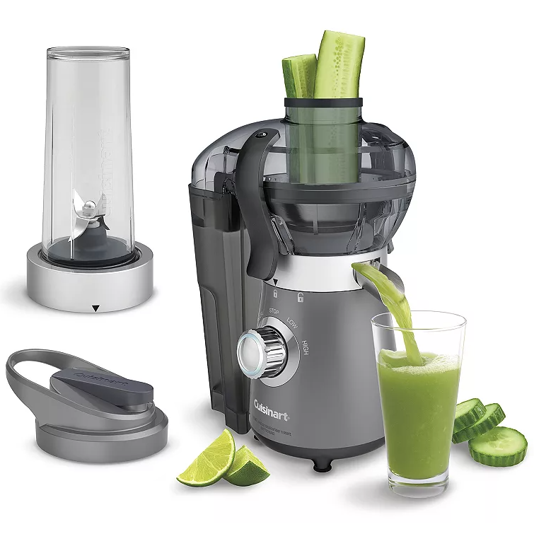 A Cuisinart blender and juice extractor with a sleek gray design, featuring a control dial with stop, low, and high settings. It is shown with a blending cup, lid, and a glass of green juice being poured, alongside sliced cucumbers and lime wedges.