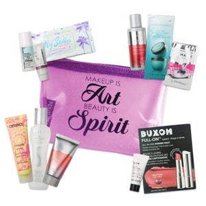 A collection of beauty products including creams, serums, a makeup bag with the phrase \“MAKEUP IS ART BEAUTY IS SPIRIT,\“ and a Buxom lip set.