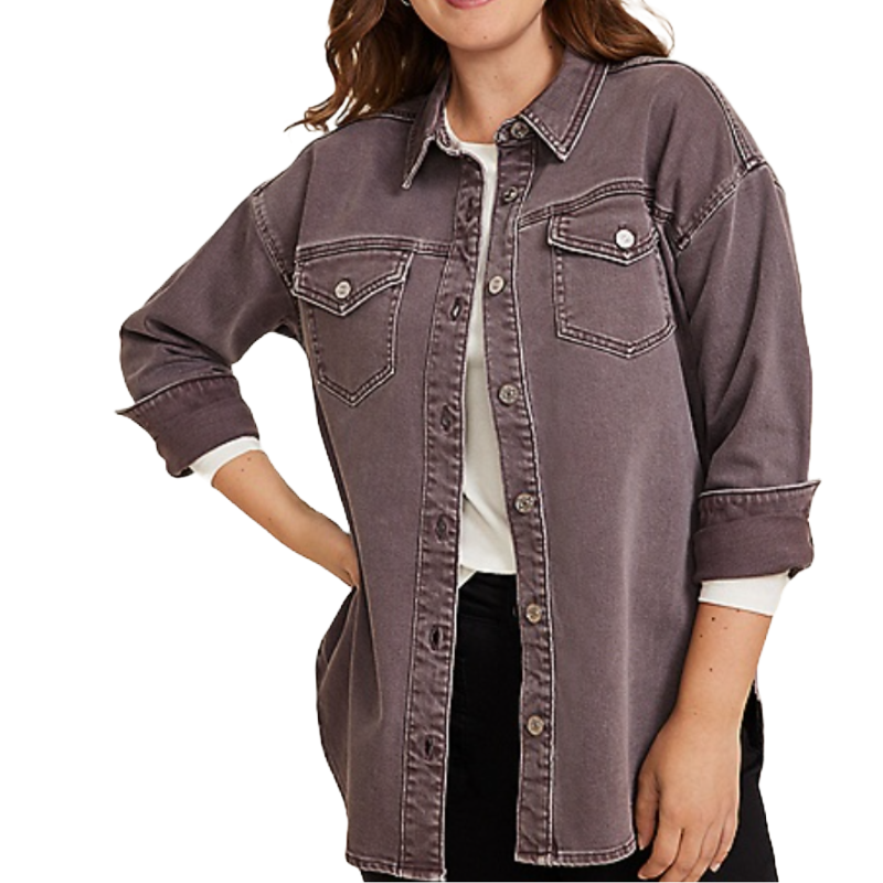 A woman wears a long-sleeve, button-up denim shirt in a faded purple color, featuring two front chest pockets and contrast stitching.