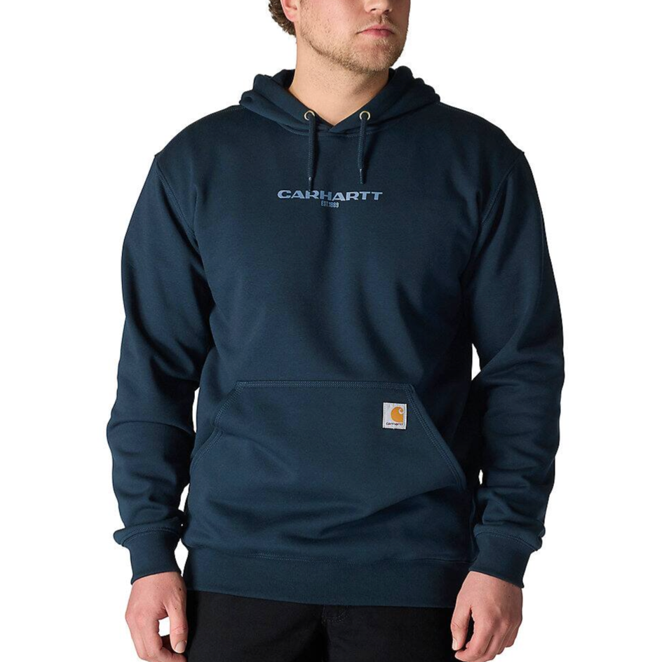A person is wearing a dark blue Carhartt hoodie with a front pouch pocket and the brand's logo on the chest.