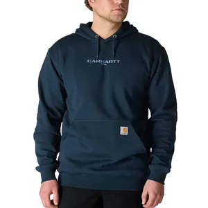 A person is wearing a dark blue Carhartt hoodie with a front pouch pocket and the brand's logo on the chest.