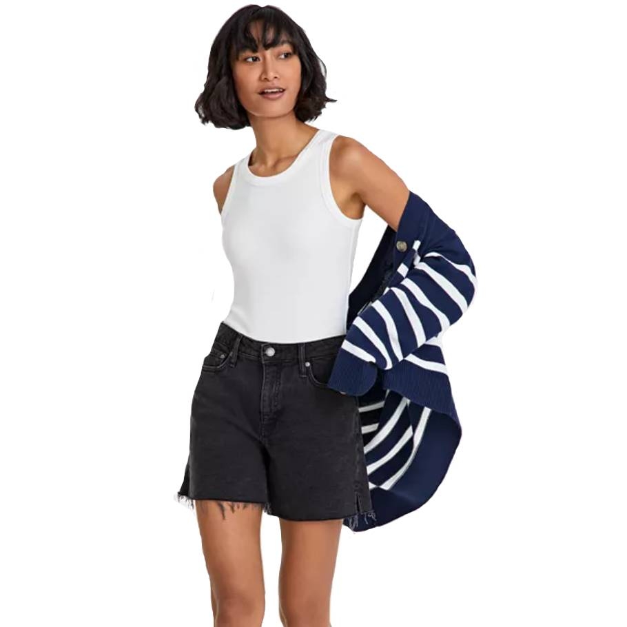 A white, sleeveless, ribbed bodysuit with a crew neckline, paired with high-waisted black denim shorts featuring frayed hems.