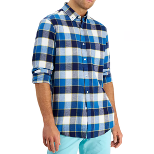 A blue and white plaid long-sleeve flannel shirt with button-down closure and a classic collar, worn slightly rolled up at the sleeves.