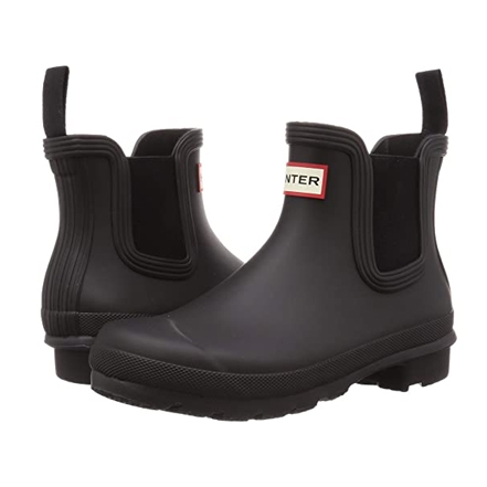 Black ankle-high rubber Chelsea boots with elastic side panels and a red Hunter logo tab on the front.