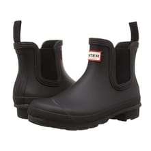 Black ankle-high rubber Chelsea boots with elastic side panels and a red Hunter logo tab on the front.