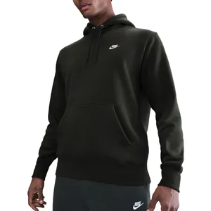 A person is wearing a dark green Nike hoodie with a small logo on the chest. The hoodie has a front pocket and drawstrings, paired with dark Nike sweatpants.