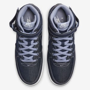 A pair of Nike Air Force 1 sneakers in a navy blue colorway with white detailing and laces.