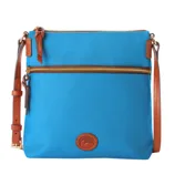 Blue crossbody bag with brown leather accents, adjustable strap, and two zippered compartments. Features a logo patch on the front.