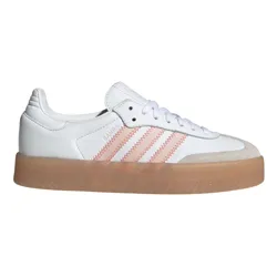 White sneaker with light pink zigzag stripes, white laces, and a translucent brown gum sole.