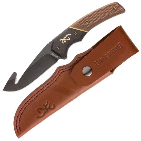 A folding knife with a gut hook and wooden handle, featuring a distinctive logo, and a leather sheath embossed with the same logo.