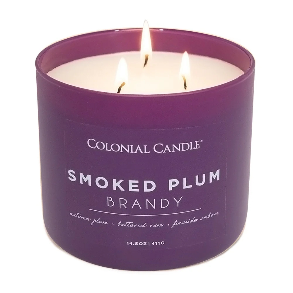 Colonial Candle Smoked Plum Brandy features scents of autumn plum, buttered rum, and fireside embers. It is a 14.5 oz (411g) candle with three wicks.