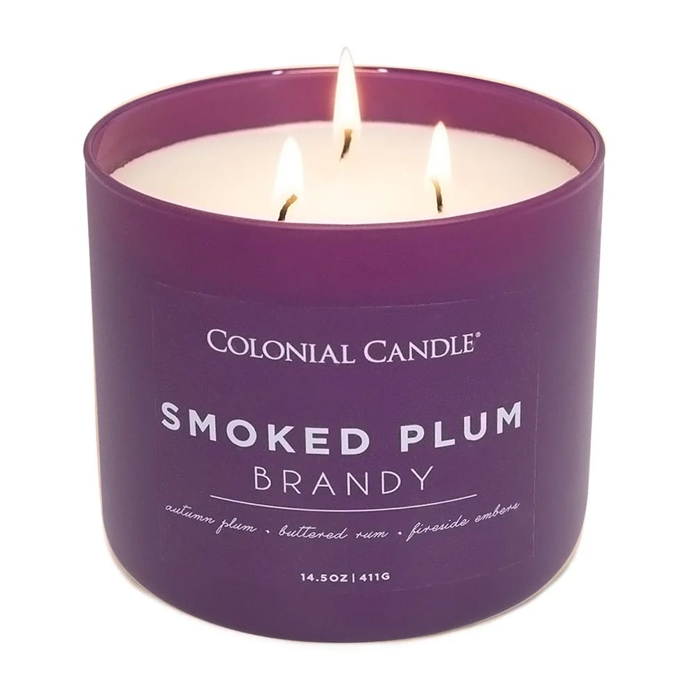 Colonial Candle Smoked Plum Brandy features scents of autumn plum, buttered rum, and fireside embers. It is a 14.5 oz (411g) candle with three wicks.