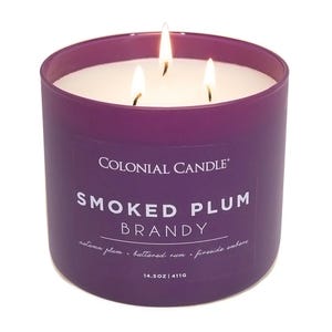Colonial Candle Smoked Plum Brandy features scents of autumn plum, buttered rum, and fireside embers. It is a 14.5 oz (411g) candle with three wicks.